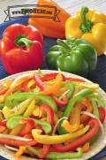 Red, yellow and green bell pepper strips are mixed with onion slices and dressing for a light and crunchy salad.
